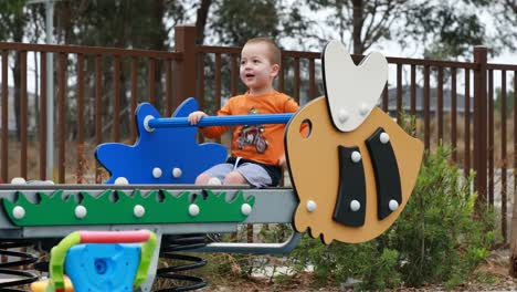 Boy-Happily-Playing-on-a-Seesaw