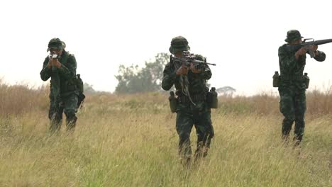 Soldado-armado-con-una-patrulla-de-reconocimiento-en-el-bosque.-Concepto-de-guerra,-ejército-y-fuerzas-armadas.