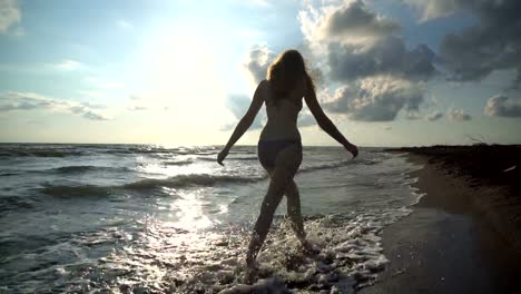 The-beautiful-blonde-in-a-bikini-walking-on-the-beach