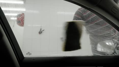 Worker-washing-car-by-foam-sponge