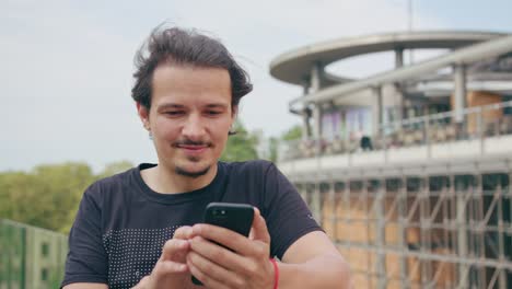 Young-Man-Using-Phone-Outdoors