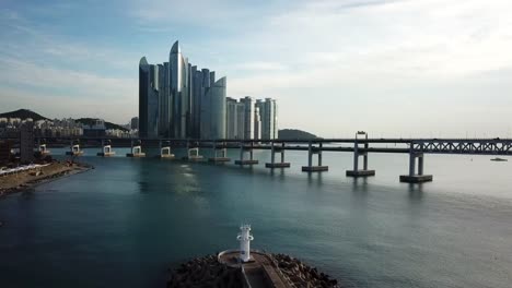 Gwangan-Bridge-and-Haeundae-aerial-view-at-Sunrise,-Busan,-South-Korea.