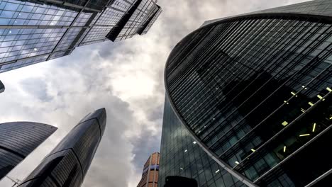 bottom-up-view-of-rotating-skyscrapers-and-flying-clouds,time-lapse,-hyper-lapse