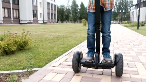 Boy-is-rolling-on-gyro-scooter-near-the-home.