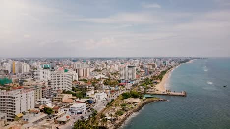 Drone-panning-left-over-amazing-coastline-and-buildings-of-Colombo,-Sri-Lanka.-Amazing-aerial-shot-of-Asian-architecture