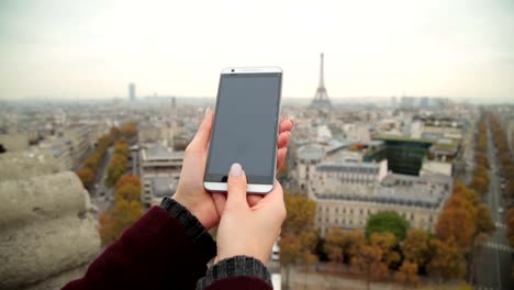 Handy-verwenden-mit-Eiffelturm,-Paris-im-Hintergrund.