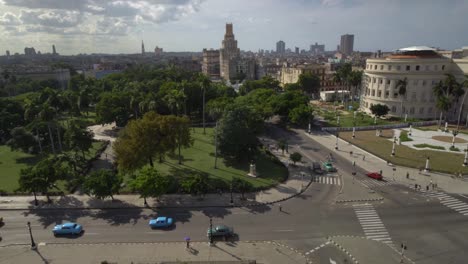 high-angle-establishing-shot-of-classic-cars-on-street,-cityscape-view-of-Havana,-Cuba