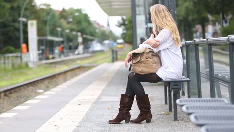 Junge-Frau-wartet-auf-die-öffentlichen-Verkehrsmittel