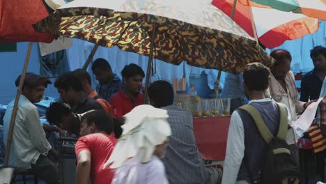 Locked-on-shot-of-people-at-market-stall,-Delhi,-India