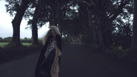 4k-Fantasy-Shot-in-Dark-Hedges,-Queen-Standing-in-the-Wind