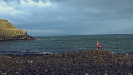 4k-Fantasy-Shot-on-Giant's-Causeway-of-a-Queen-Standing-in-Wind