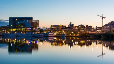 Stockholm-Waterfront-Bürogebäude-spät-Sommernacht-4K-Zeitraffer-kippen.-Hauptstadt-von-Schweden,-Turmdrehkran,-Spiegelbild-im-Wasser