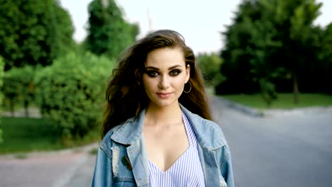 Portrait-of-pretty-girl-in-casual-posing-with-heavy-makeup-keeping-eyes-closed-and-looking-content