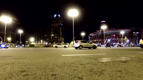 Night-traffic-at-Plaza-de-Espagna-with-view-of-Old-Arena-building-in-Barcelona,-Catalonia,-Spain
