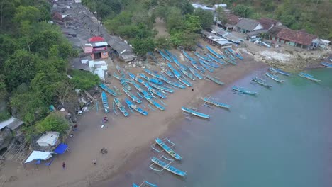 Baron-beach-traditional-fishing-boats-docked-to-the-shore-aerial-view,-Yogyakarta,-Indonesia