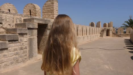 Girl-walking-at-fortress-background