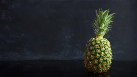 Stop-motion-ripe-tropical-fruit-pineapple-on-a-black-background.-Time-lapse-food-footage