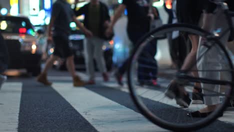 Road-Crossing-Busy-with-People-in-the-Big-City-at-Night.-Crowds-Of-People-Walking-on-Crosswalk-with-Bright-Advertising-Billboards-in-thre-Background.