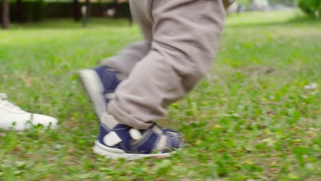 Mother-Helping-Baby-Taking-First-Steps