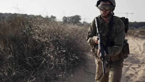 Israeli-soldier-pointing-his-rifle-and-scanning-the-area---slow-motion