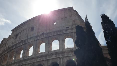 A-ray-of-sun-passes-through-the-arches-of-the-Colosseum-in-Rome,-Italy.