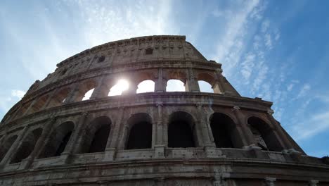 A-ray-of-sun-passes-through-the-arches-of-the-Colosseum-in-Rome,-Italy.