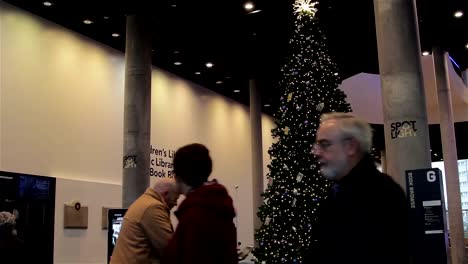 Tilt-Down-Large-Christmas-Tree-in-Birmingham-as-people-enjoy-Xmas-Lights