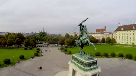 Hero's-square-Heldenplatz-in-Vienna-city,-horse-rider-green-park.-Beautiful-aerial-shot-above-Europe,-culture-and-landscapes,-camera-pan-dolly-in-the-air.-Drone-flying-above-European-land.-Traveling-sightseeing,-tourist-views-of-Austria.