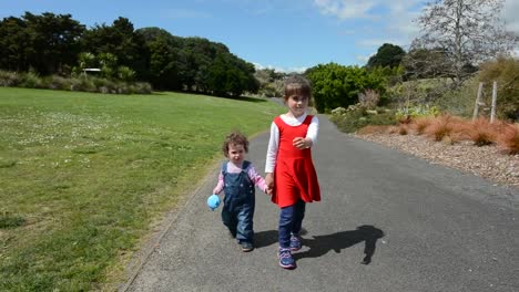 Two-sisters-holding-hands