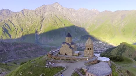 aerial.-Gergeti-orthodox-church-high-in-the-mountains,-Georgia