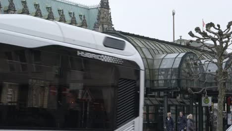 People-passing-on-the-road-at-City-Hall-of-Hamburg-Bus-Station-on-a-cloudy-day