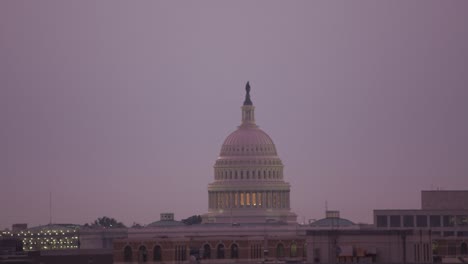 Reveal-United-States-Capitol-building-from-behind-buildings-at-sunrise.