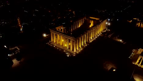 Aerial-night-video-of-iconic-ancient-Acropolis-hill-and-the-Parthenon-at-night,-Athens-historic-center