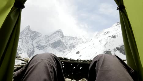 Feet-Man-relaxing-enjoying-clouds-mountains-aerial-view-from-tent-camping.