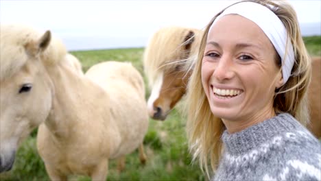 Selfie-portrait-in-slow-motion-of-young-woman-with-Icelandic-horses