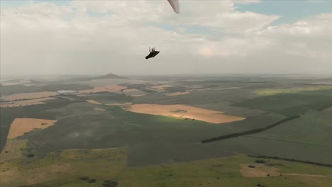 Athlete-paraglider-flies-on-his-paraglider-next-to-the-swallows.-Follow-up-shooting-from-the-drone