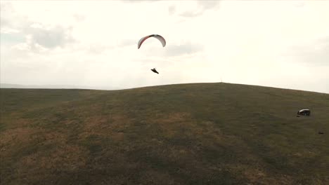 Athlete-paraglider-flies-on-his-paraglider-next-to-the-swallows.-Follow-up-shooting-from-the-drone