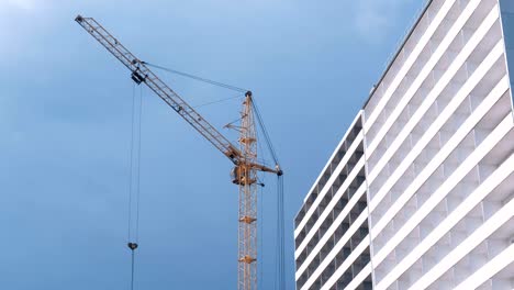 Construction-of-a-multi-storey-building.-House-and-construction-crane-on-sky-background.