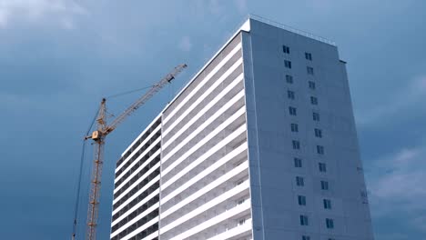 Construction-of-a-multi-storey-building.-House-and-construction-crane-on-sky-background.