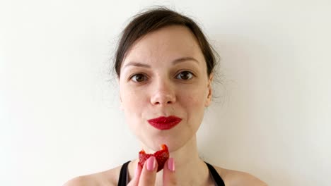 Portrait-of-woman-eating-strawberries.-Front-view.