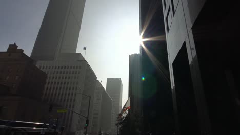 movimiento-tiro-a-lo-largo-de-la-pared-de-un-rascacielos-moderno-en-el-centro-de-Los-Angeles,-en-un-día-soleado