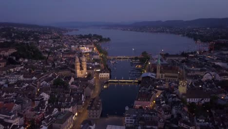 night-illuminated-zurich-city-center-riverside-lake-view-aerial-panorama-4k-switzerland