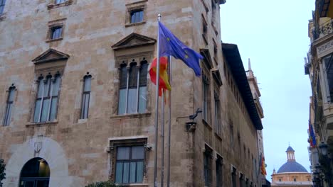 Flags-of-the-European-Union,-Spain-and-Valencia-on-the-chrome-plated-flagpoles