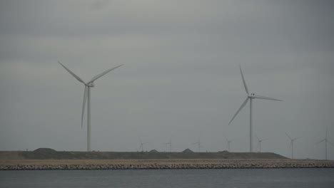 The-theme-is-net-power-generation-and-environmental-protection.-A-number-of-wind-blades,-wind-power-in-the-Baltic-Sea-in-Europe-Denmark-Copenhagen-in-winter