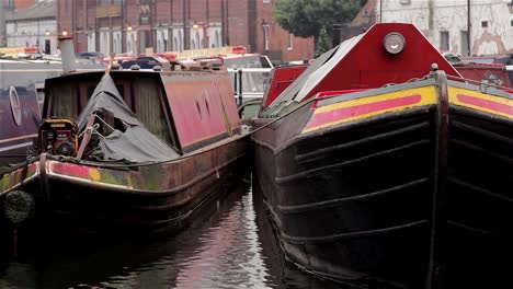 Tilt-To-Close-Up-of-Narrow-Boat-Barges-Docked-in-Canal-Harbor