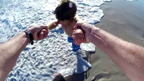 POV-of-Father-swinging-happy-child-on-beach,Cape-Town