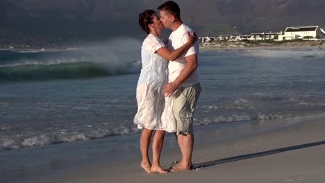Man-and-woman-enjoying-romantic-embrace-on-the-beach,-Cape-Town,South-Africa