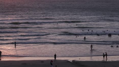 People-swimming-at-sunset-at-a-Cape-Town-Beach,South-Africa