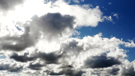 Commercial-Passenger-Airliner-during-Vertical-Overhead-Flyover-on-a-Sunny-Day-with-White-Clouds