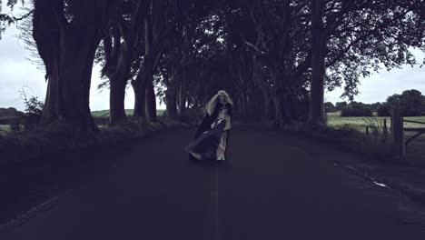 4k-Fantasy-Shot-in-Dark-Hedges,-Queen-Walking-to-Camera